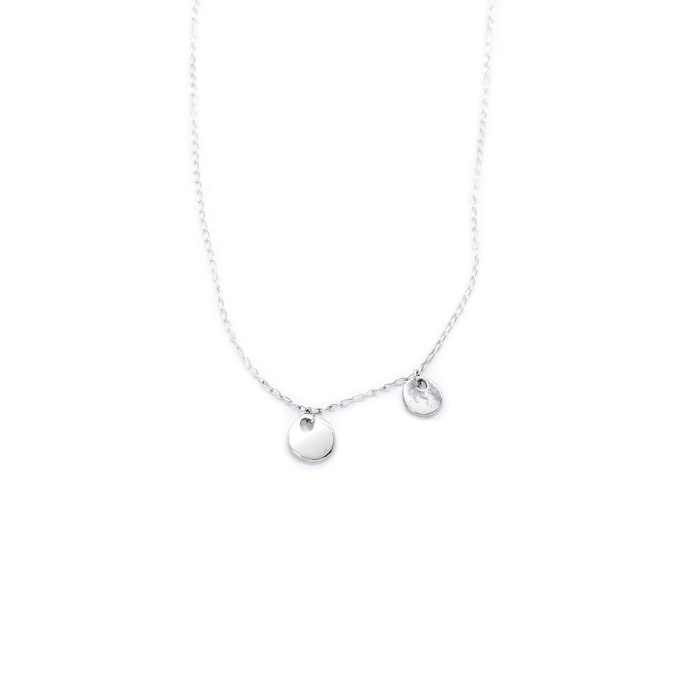 Handcrafted silver organic coin pendant necklace by Atelier Objectora, featuring a irregular medallion design, timeless and versatile