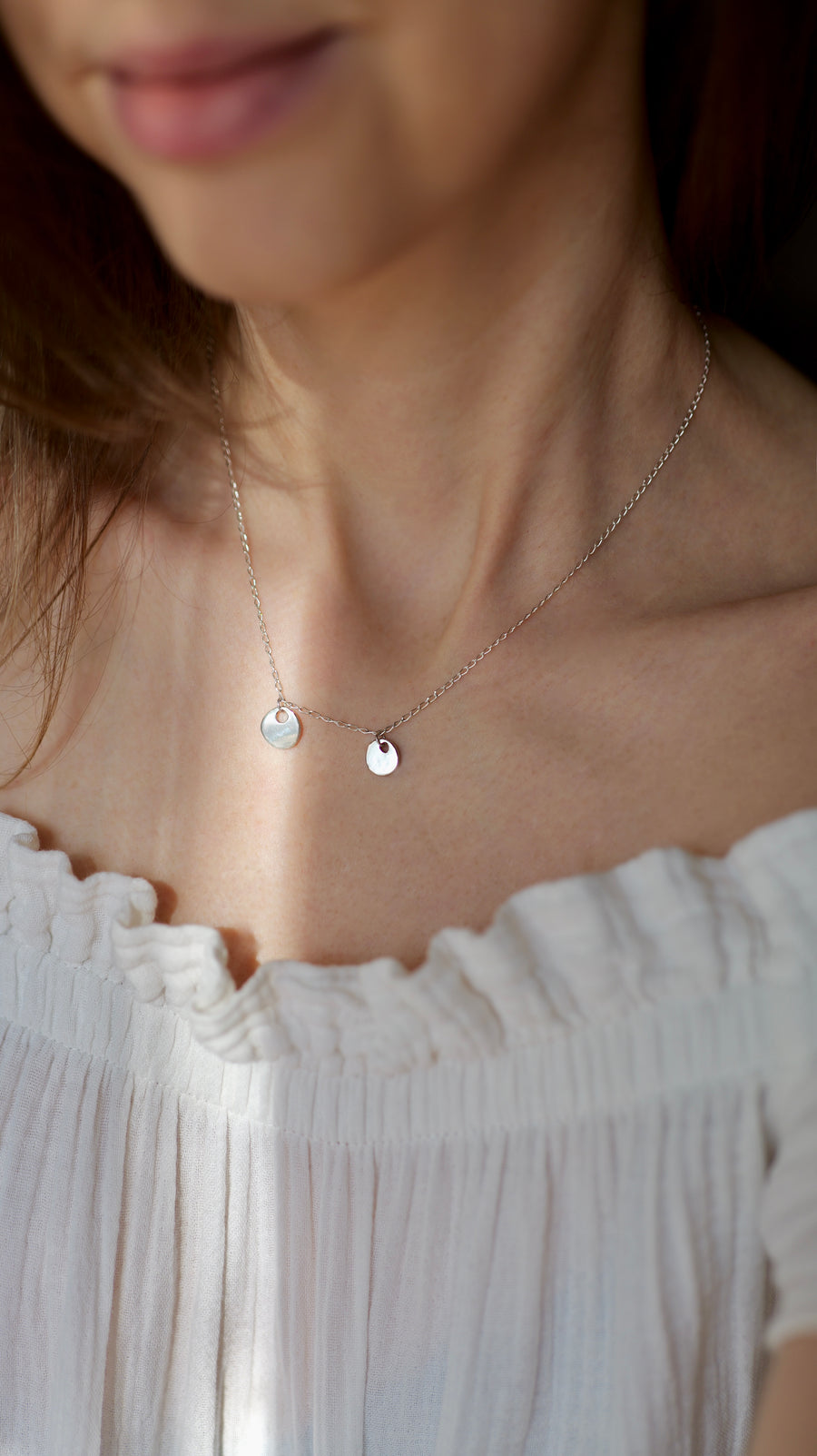Handcrafted silver organic coin pendant necklace by Atelier Objectora, featuring a irregular medallion design, timeless and versatile
 Ručne vyrobený strieborný náhrdelník s organickým okrúhlym príveskom od Atelier Objectora, s nepravidelným medailónom, nadčasový a univerzálny