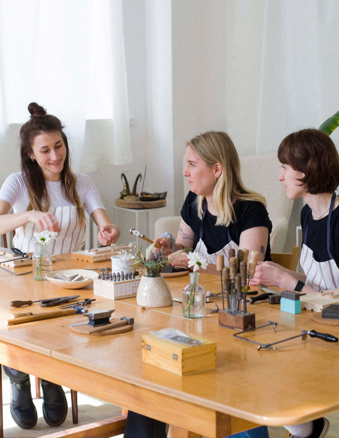 a group of friends enjoying a silver jewelry making workshop at atelier objectora